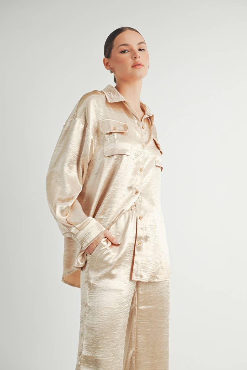Champagne satin button-down shirt with a relaxed fit, two front pockets, and a subtle sheen.