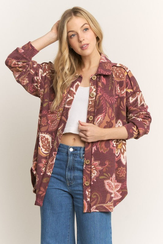 Burgundy Long-sleeve paisley shacket with a collar, ribbed texture, button front, stitched details, and a rounded hem.
