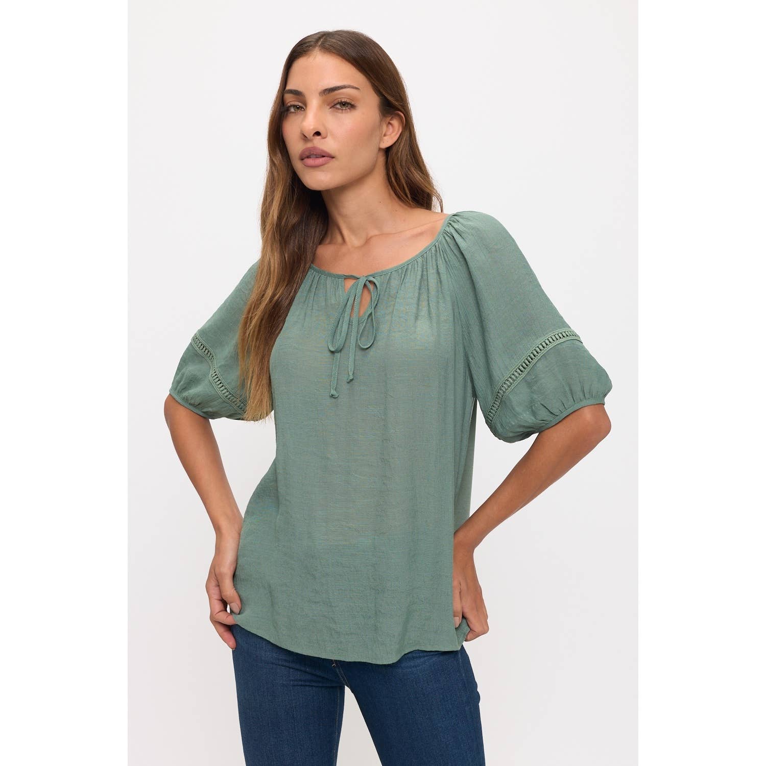 Peasant top with a tie-front keyhole neckline, short sleeves, and crochet trim on the sleeves in Sea Green color.