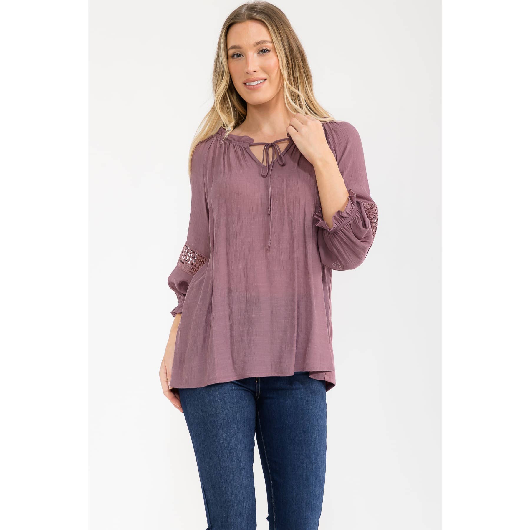 Long-sleeve peasant top with a tie neck, ruffled neckline, and lattice crochet trim