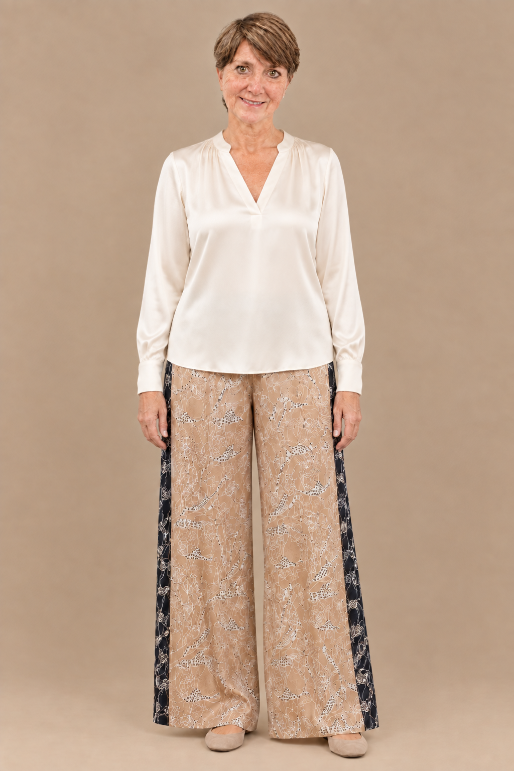 You in an ivory silk V-neck blouse with the printed pants
